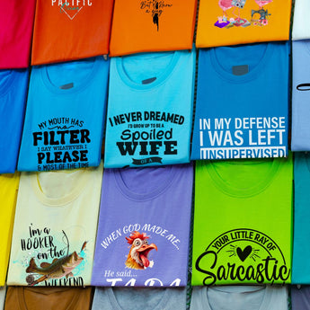 A colorful collection of women's funny graphic tanks and tees, featuring witty quotes and quirky graphics.
