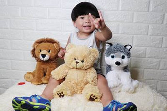 Enchanted Companions: stuffed animals featuring a lion, bear and wolf with a little boy.