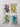 Four small clear plastic bags containing translucent, glossy, bear-shaped decorative pieces in purple, yellow, green, and blue, arranged in a 2x2 grid on a white background.