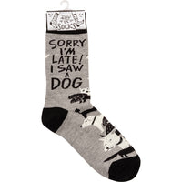 Grey and black 'Sorry I'm late I Saw a dog' crew socks with woven dog designs and saying, designed by Johnny Carrillo makes a unique gift for dog lovers.