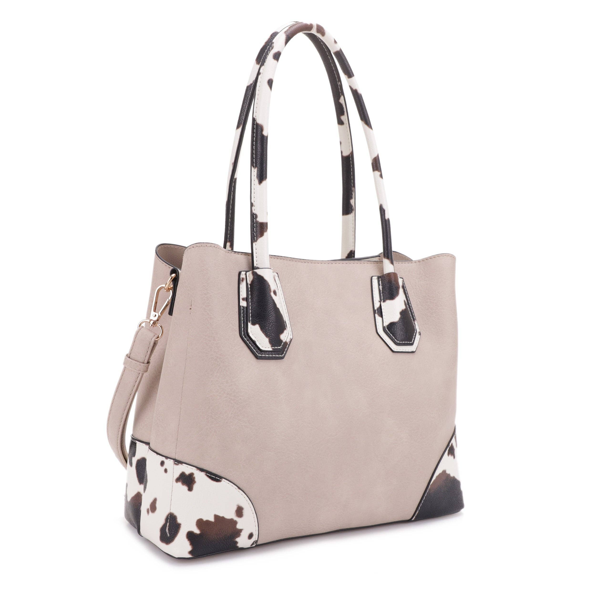 Beige Vegan Leather Handbag with Brown cow print accents and handles. 