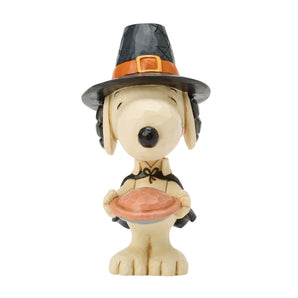 Jim Shore Peanuts Snoopy with Pumpkin Pie Mini figurine featuring Snoopy holding a freshly baked pumpkin pie with hand-painted folk-art details and autumn colors.