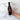 Hand holding a bottle of Olivelle Harvest Fig balsamic vinegar with text highlighting its features on a marble background.