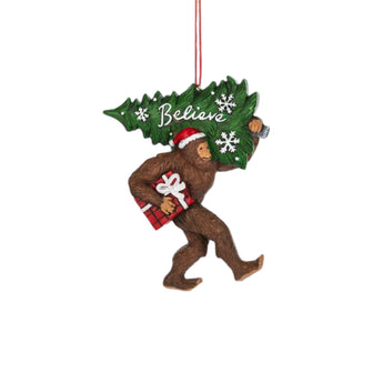 Bigfoot "Believe" Christmas Ornament with sasquatch with santa hat on carrying a present and a christmas tree 