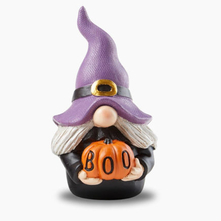 Purple Hat Halloween Witch Gnome with pumpkin carved with "Boo" on it.