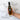 Bottle of Olivelle Caramelized Garlic Infused olive oil held by a hand with text highlighting features on a marble background.