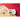 White baking dish with illustrated baking scene on a red wooden surface