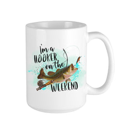 White 15 oz ceramic coffee mug with humorours fishing phrase 'I'm a Hooker on the Weekend' and a watercolor fish taking the bait, with a watercolor water background.