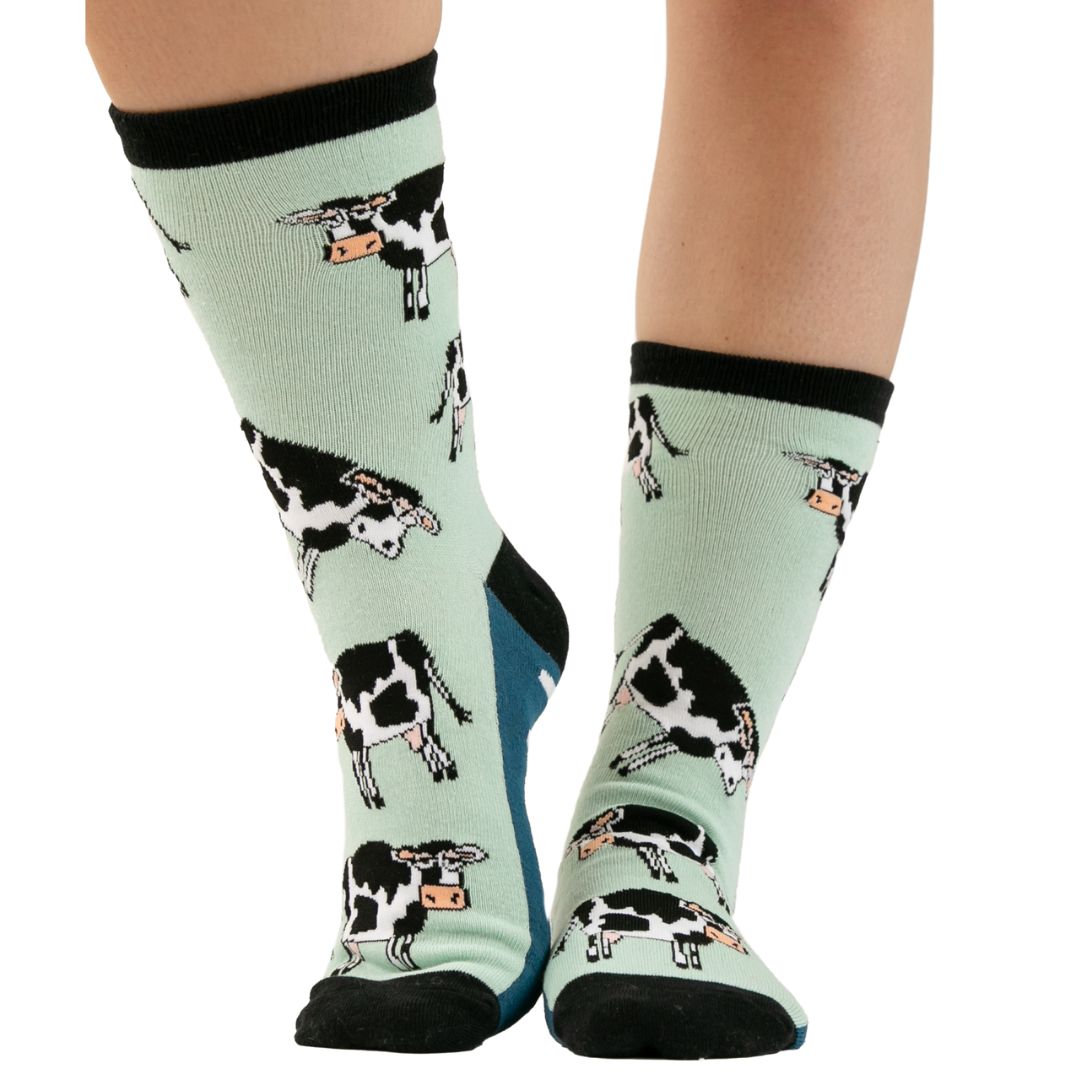 Moody in the Morning cow print crew socks in Honey Dew Blue, Lyons Blue, and Black, with 'Moody' text on the bottom, perfect for a fun and comfortable start to the day