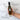 Bottle of Olivelle olive oil held by a hand with text highlighting features on a white marble background