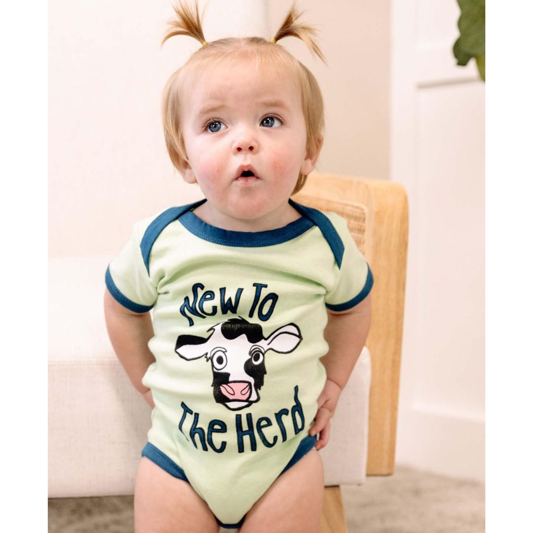 Patina Green 'New to the Herd' infant creeper bodysuit with contrasting trim, snaps at crotch and neck, made from 100% combed cotton
