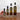 Four bottles of Olivelle Sicilian Lemon olive oil with labeled volumes on a marble background.