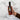 Hand holding a bottle of Olvelle Strawberry Lemonade with text highlighting its features on a marble background.
