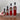 Four bottles of Olivelle Strawberry Lemonade with labeled volumes on a marble background