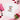 White t-shirt with colorful graphic and text on a pink background with roses and chocolate.