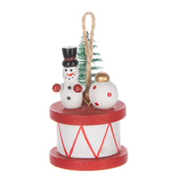 Vintage Snowman sitting on a wooden spool with Christmas tree and ornament