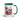 Holiday coffee mug featuring snowman in festive cup graphics with green handle