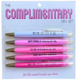 Image of The Complimentary Pen Set, featuring five pens with black ink, each adorned with heartwarming complimentary sayings like 'you are very easy to like' and 'your jokes are hilarious'. These pens are in a package of 5, highlighting the desing and showing the uplifting messages meant to inspire and spread positivity.