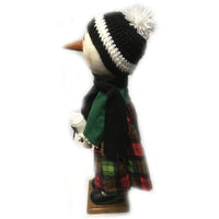 Standing Snow Girl in Christmas dress holding her little sock snowman
