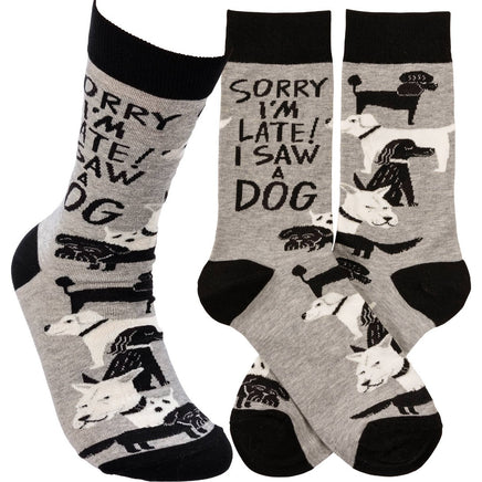Grey and black Sorry I'm Late I Saw A Dog crew socks with woven dog designs and saying, designed by Johnny Carrillo.